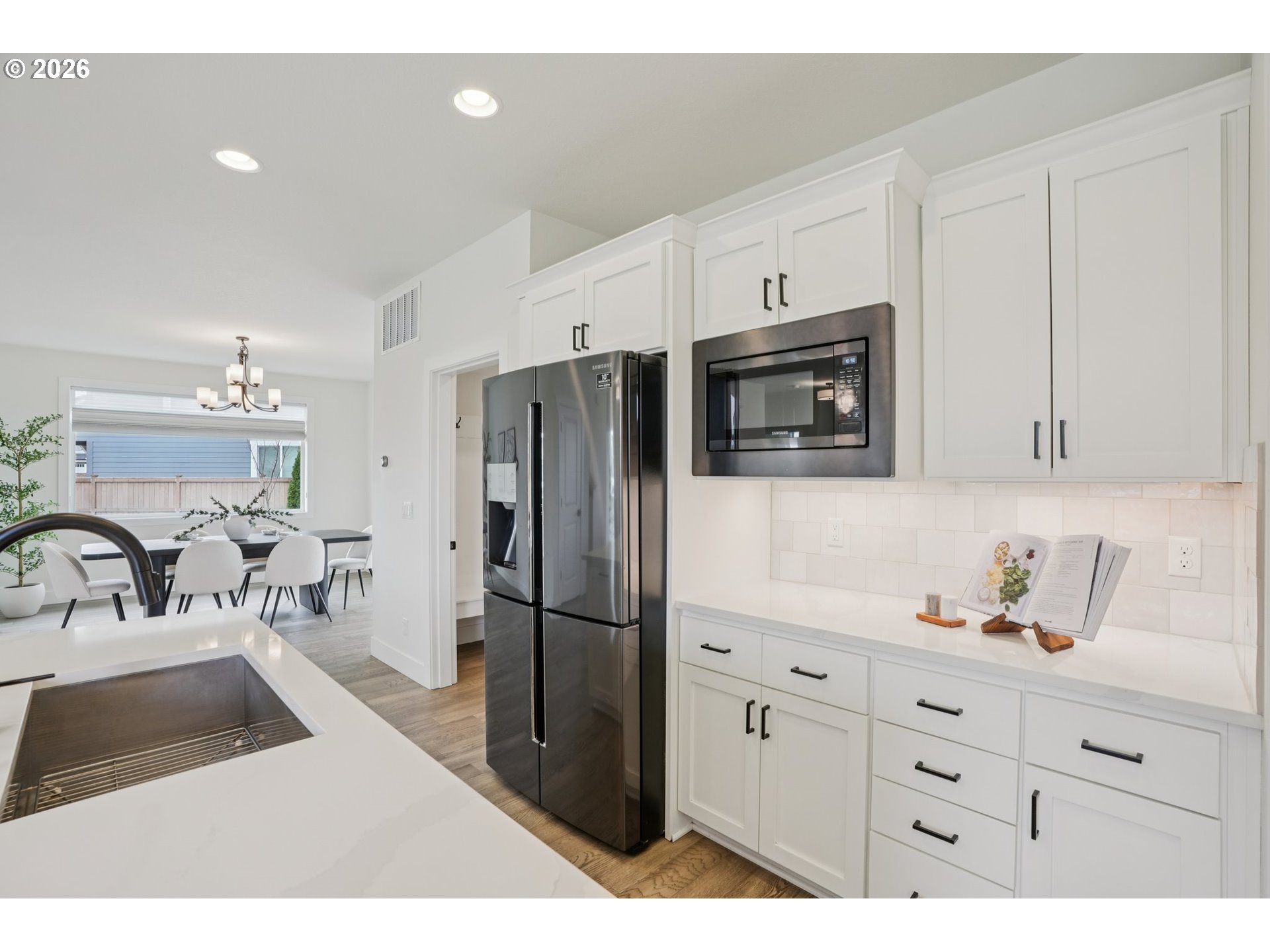3809 Southeast Reed Drive Hillsboro, OR 97123 - Photo 12 of 40 a kitchen with granite countertop a refrigerator and a sink