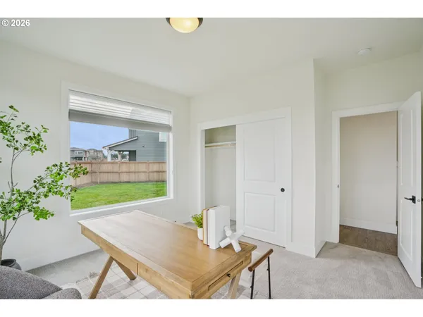 a view of a room that has a table and chairs in it