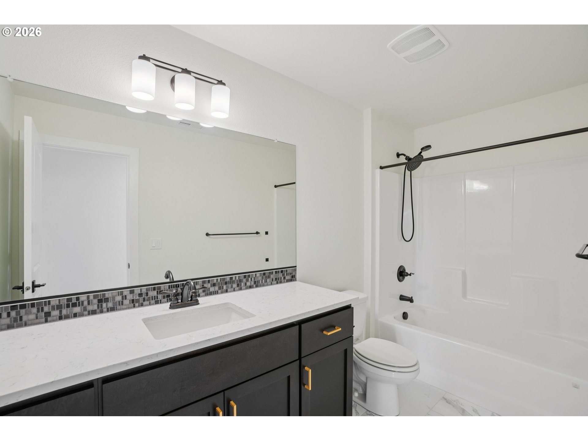 3809 Southeast Reed Drive Hillsboro, OR 97123 - Photo 22 of 40 a bathroom with a sink a toilet a mirror and shower