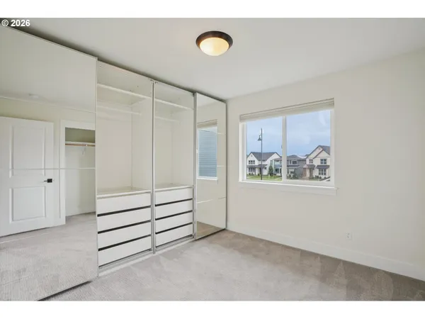 a view of a bedroom with furniture and cabinet