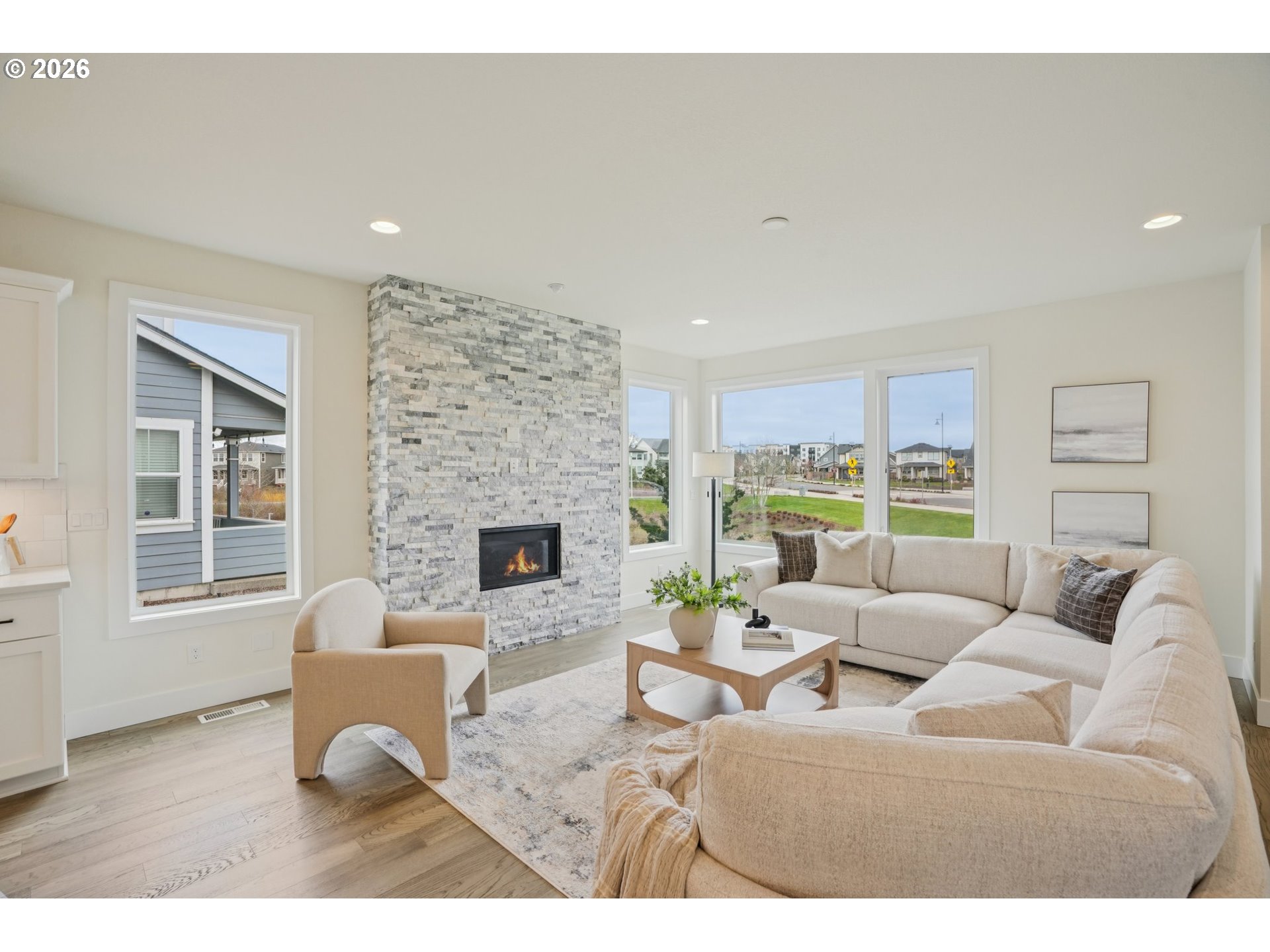 3809 Southeast Reed Drive Hillsboro, OR 97123 - Photo 5 of 40 a living room with furniture potted plant a fireplace and a window