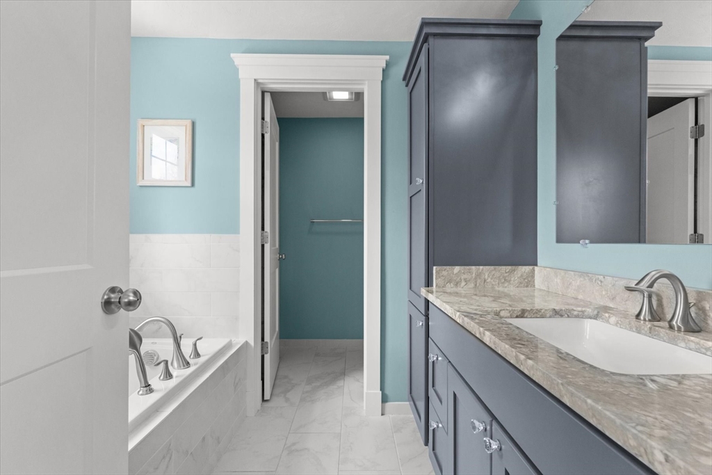 50 Quabbin Path Sutton, MA 01590 - Photo 25 of 42 a bathroom with a granite countertop sink and a mirror
