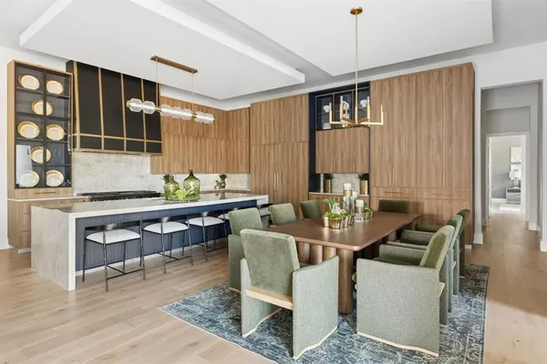 a dining room with furniture and wooden floor