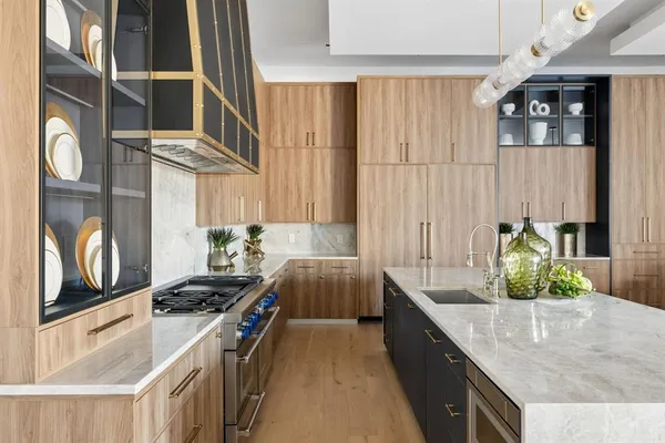 a kitchen with stainless steel appliances granite countertop a lot of counter space and a sink