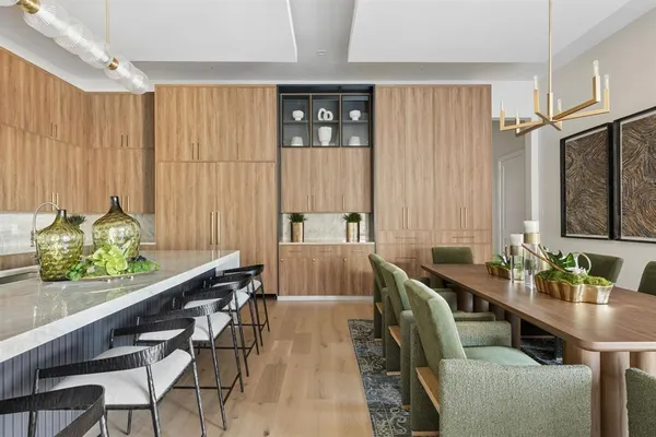 a dining room with furniture and a window