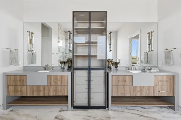 a bathroom with a double vanity sink mirror and shower
