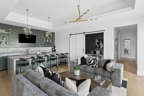 a kitchen with a sink and chairs