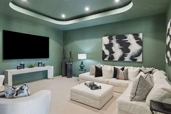 a bedroom with a bed and large windows