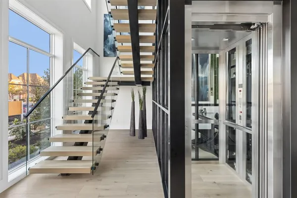 a view of entryway and hall with wooden floor