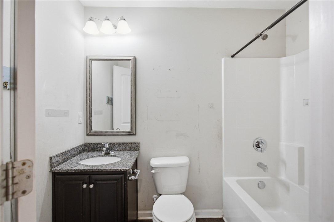 245 Maple Grove Road Seneca, SC 29678 - Photo 18 of 40 This bathroom features a sleek vanity with a mirror and a clean, functional tub.
