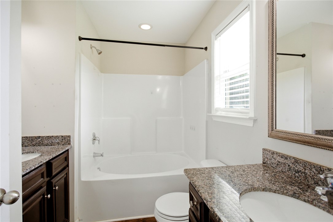 245 Maple Grove Road Seneca, SC 29678 - Photo 23 of 40 This bathroom features granite countertops and a window that provides natural light.