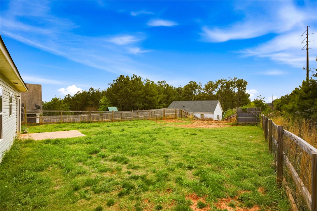 245 Maple Grove Road Seneca, SC 29678 - Photo 33 of 40 Expansive backyard with privacy fencing, offering ample green space and a separate outbuilding.