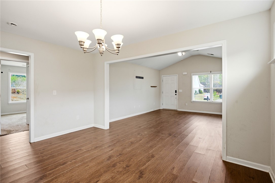 245 Maple Grove Road Seneca, SC 29678 - Photo 10 of 40 This inviting space features durable hardwood floors, high ceilings, and a classic chandelier for timeless appeal.