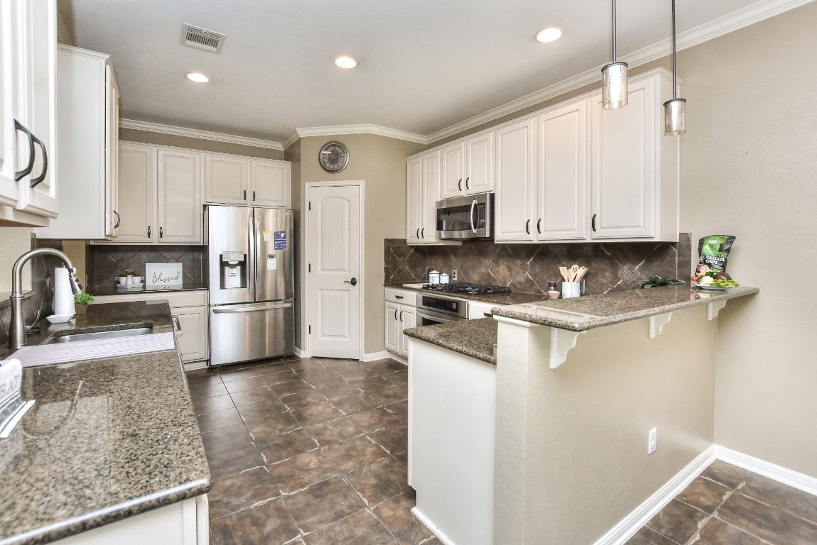 1108 Ritter Drive Cedar Park, TX 78613 - Photo 15 of 40 There is also a big walk-in pantry and breakfast bar for additional seating space.