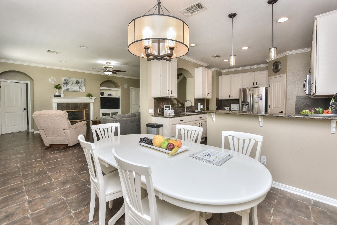 1108 Ritter Drive Cedar Park, TX 78613 - Photo 16 of 40 This breakfast/casual dining area offers plenty of space for a formal dining table if needed.