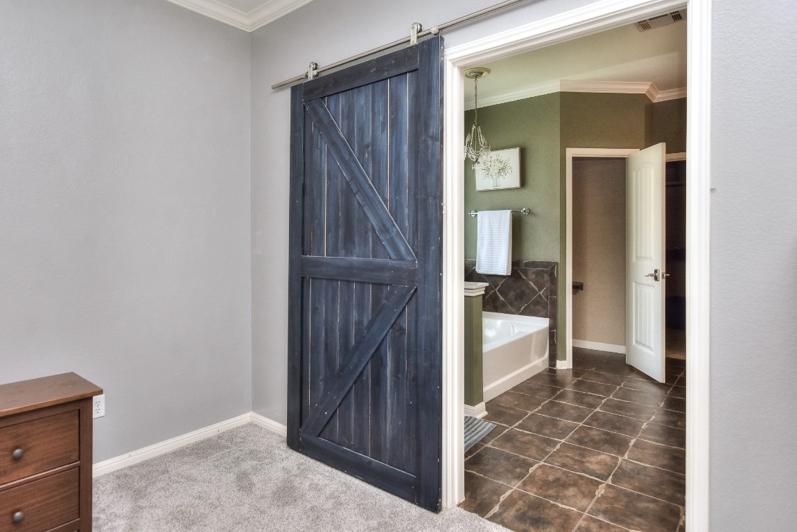 1108 Ritter Drive Cedar Park, TX 78613 - Photo 21 of 40 A charming rustic barn door welcomes you to the spa-like primary bathroom!