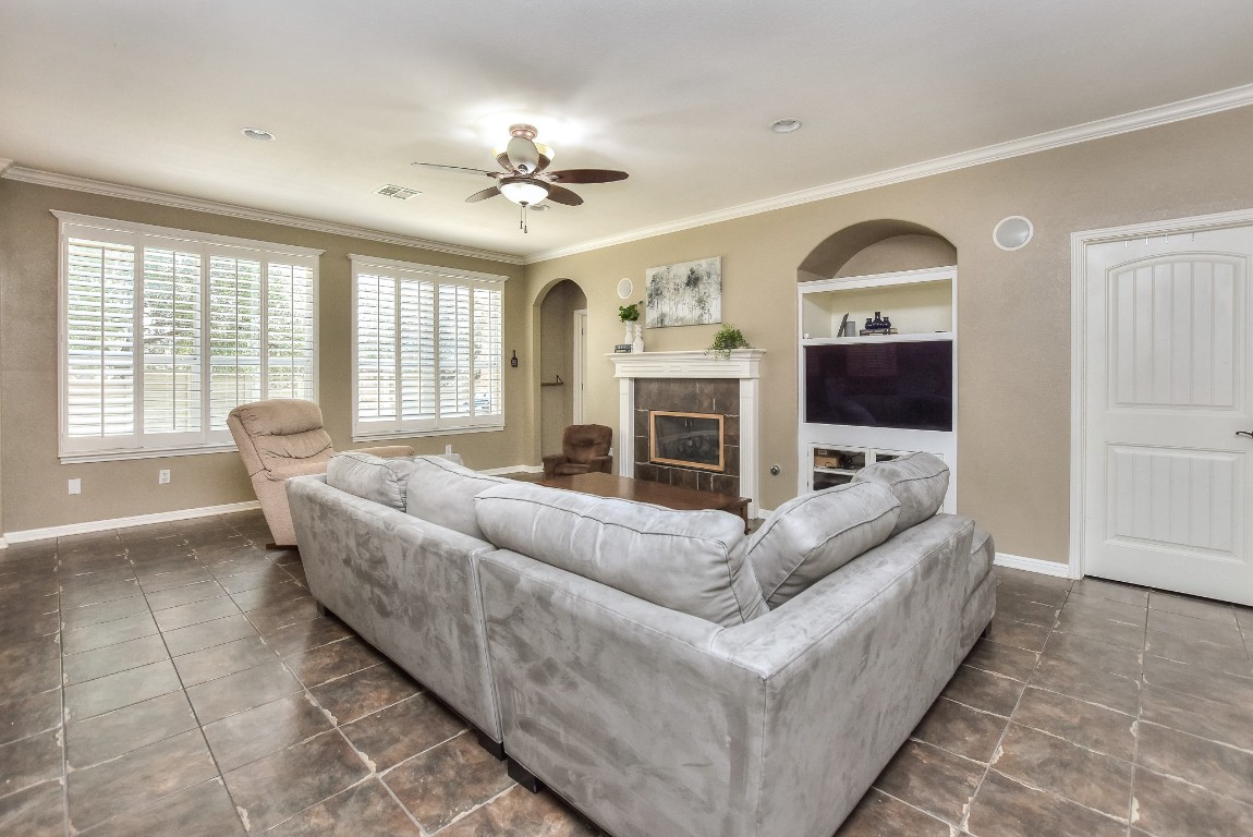 1108 Ritter Drive Cedar Park, TX 78613 - Photo 8 of 40 The large light-filled family room has a gas log fireplace, plantation shutters, and built-in cabinetry.
