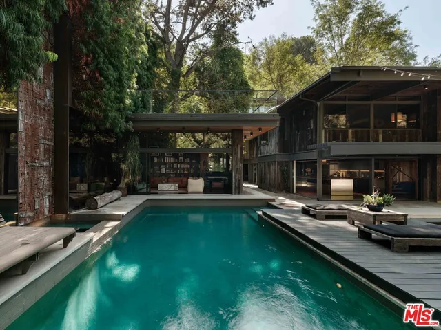 a view of a house with swimming pool and sitting area
