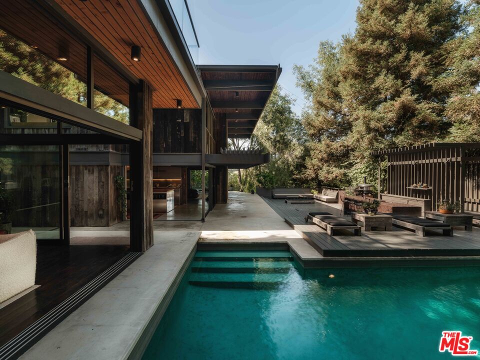 2563 Nichols Canyon Road Los Angeles, CA 90046 - Photo 15 of 32 a view of a house with backyard porch and sitting area