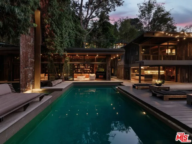 a view of a house with backyard porch and sitting area