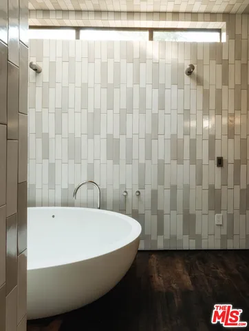 a bathroom with a bathtub and shower