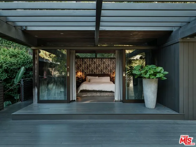 a bed sitting in a bedroom next to a window