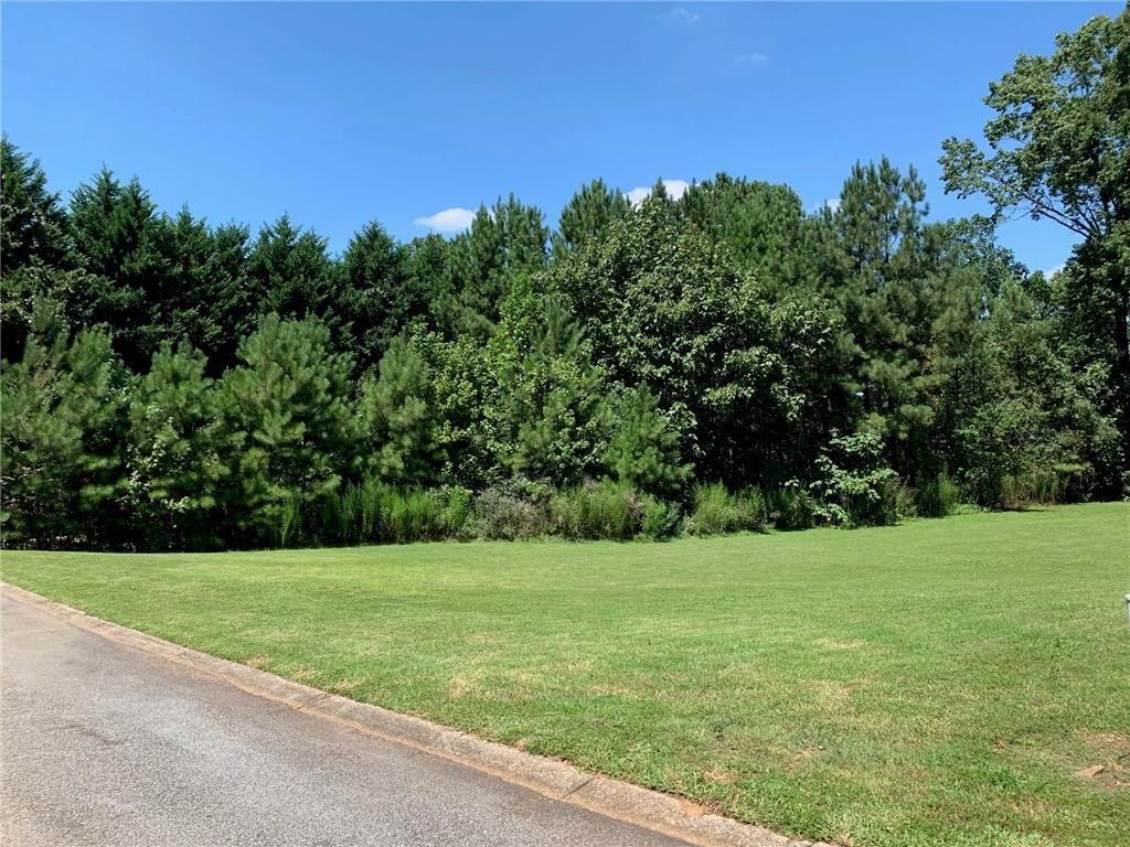8141 Nesbit Ferry Road Atlanta, GA 30350 - Photo 2 of 3 a view of a grassy field with trees in the background