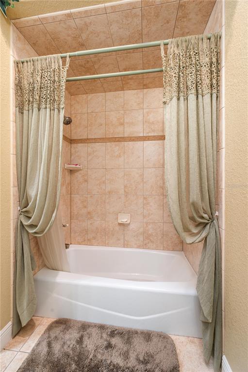 35 Stembridge Road Lake Wales, FL 33898 - Photo 38 of 61 a bathroom with a bathtub and a shower