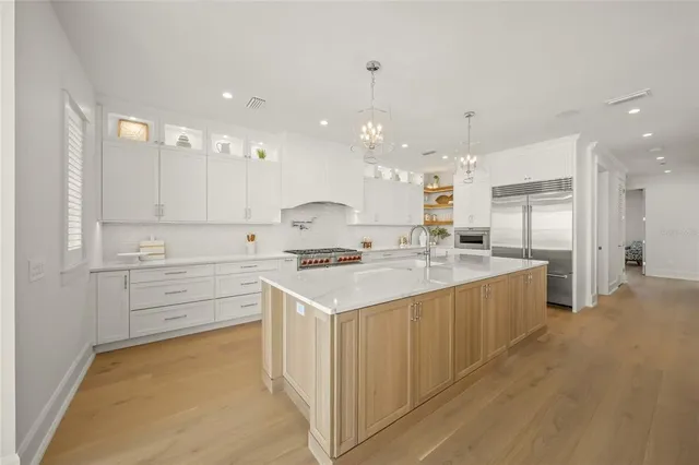 a large kitchen with a table and chairs