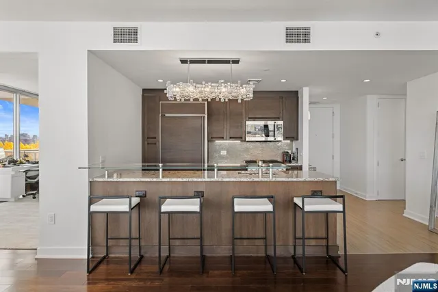 a kitchen with kitchen island granite countertop a table and chairs in it
