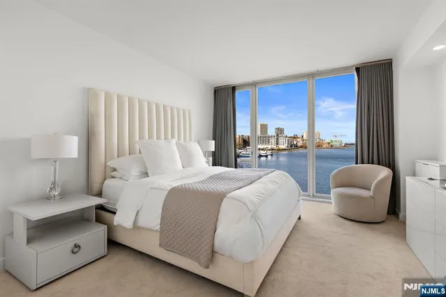 a bedroom with furniture and a large window