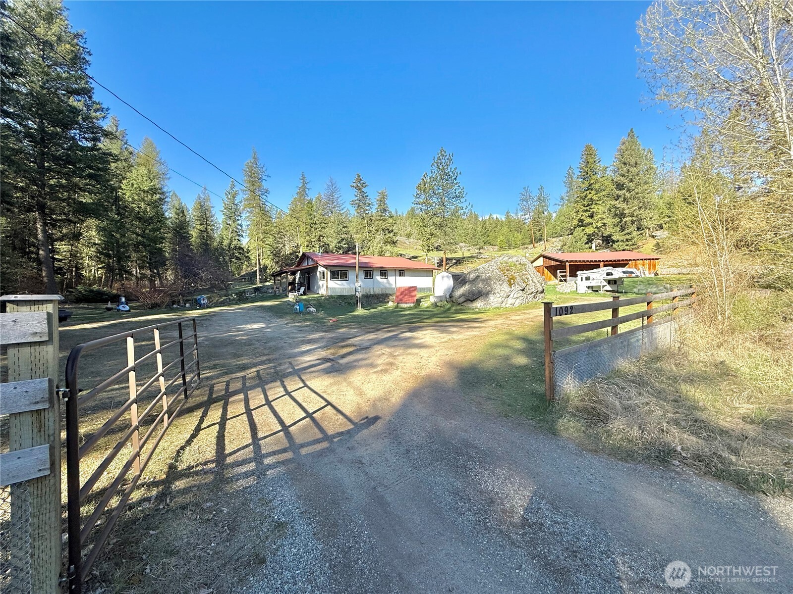 1092 Aeneas Valley Road Tonasket, WA 98855 - Photo 2 of 40 a view of swimming pool with outdoor seating and a yard