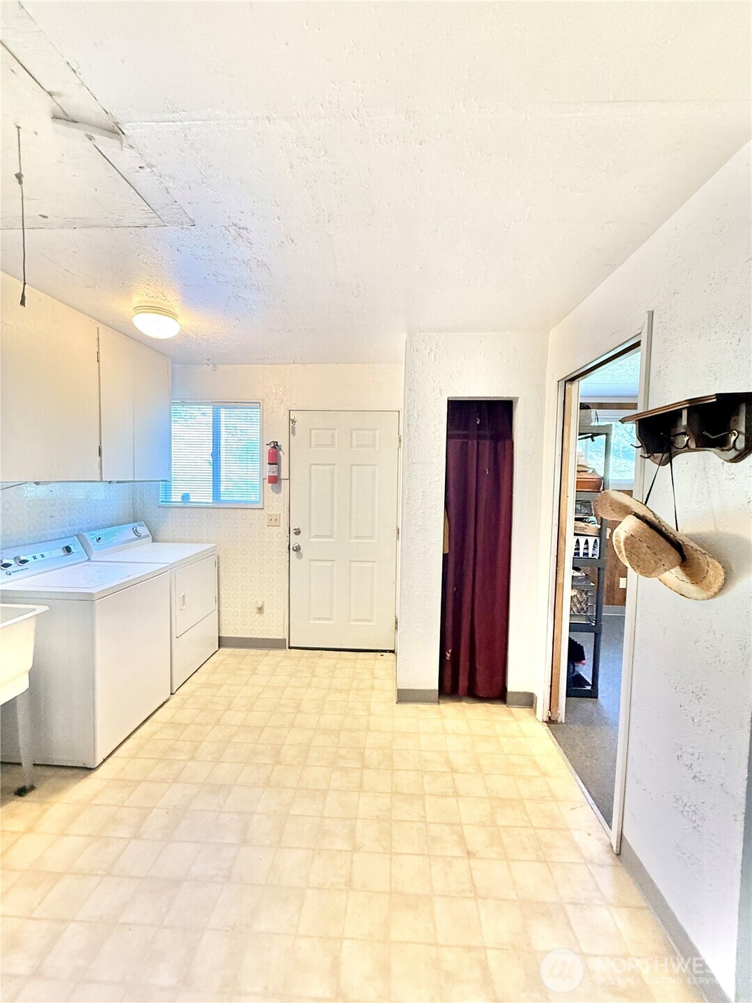 1092 Aeneas Valley Road Tonasket, WA 98855 - Photo 37 of 40 a view of a kitchen with a sink and a refrigerator
