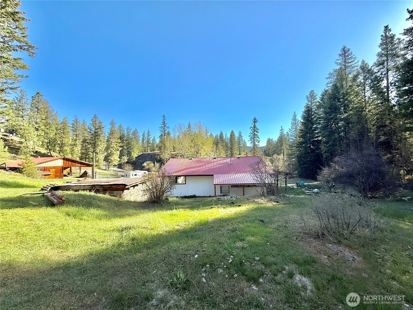1092 Aeneas Valley Road Tonasket, WA 98855 - Photo 6 of 40 a swimming pool with trees in the background