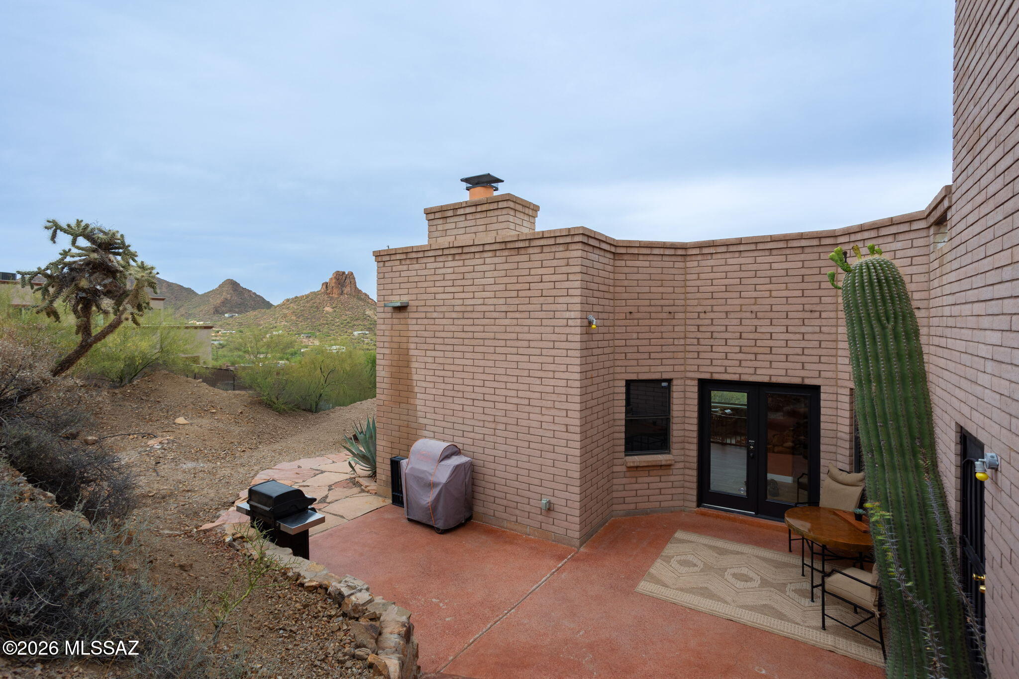 4210 West Mossman Road Tucson, AZ 85746 - Photo 37 of 51 a view of a house with a floor to ceiling window and potted plants