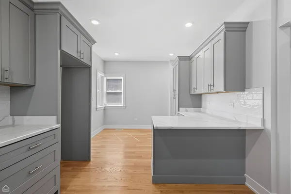 a kitchen with stainless steel appliances granite countertop a sink and a stove