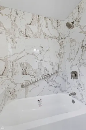 a bathroom with a bathtub and a shower