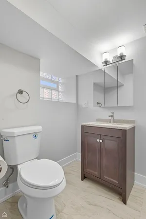 a bathroom with a sink a toilet and mirror