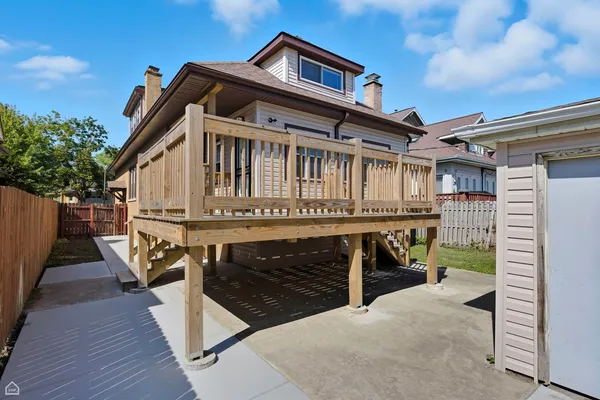 a view of house with a balcony and wooden floors