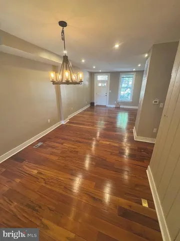 a view of a room with wooden floor and window