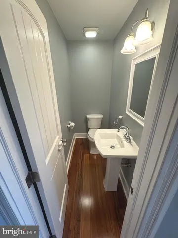 a bathroom with a sink a toilet a mirror and vanity