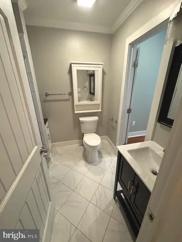 a bathroom with a sink a toilet a mirror and vanity