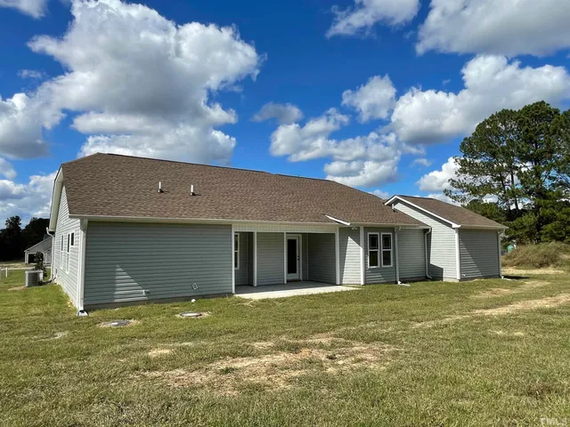 a view of a house with a backyard