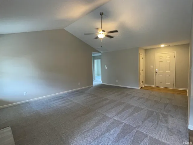 a view of an empty room with a ceiling fan