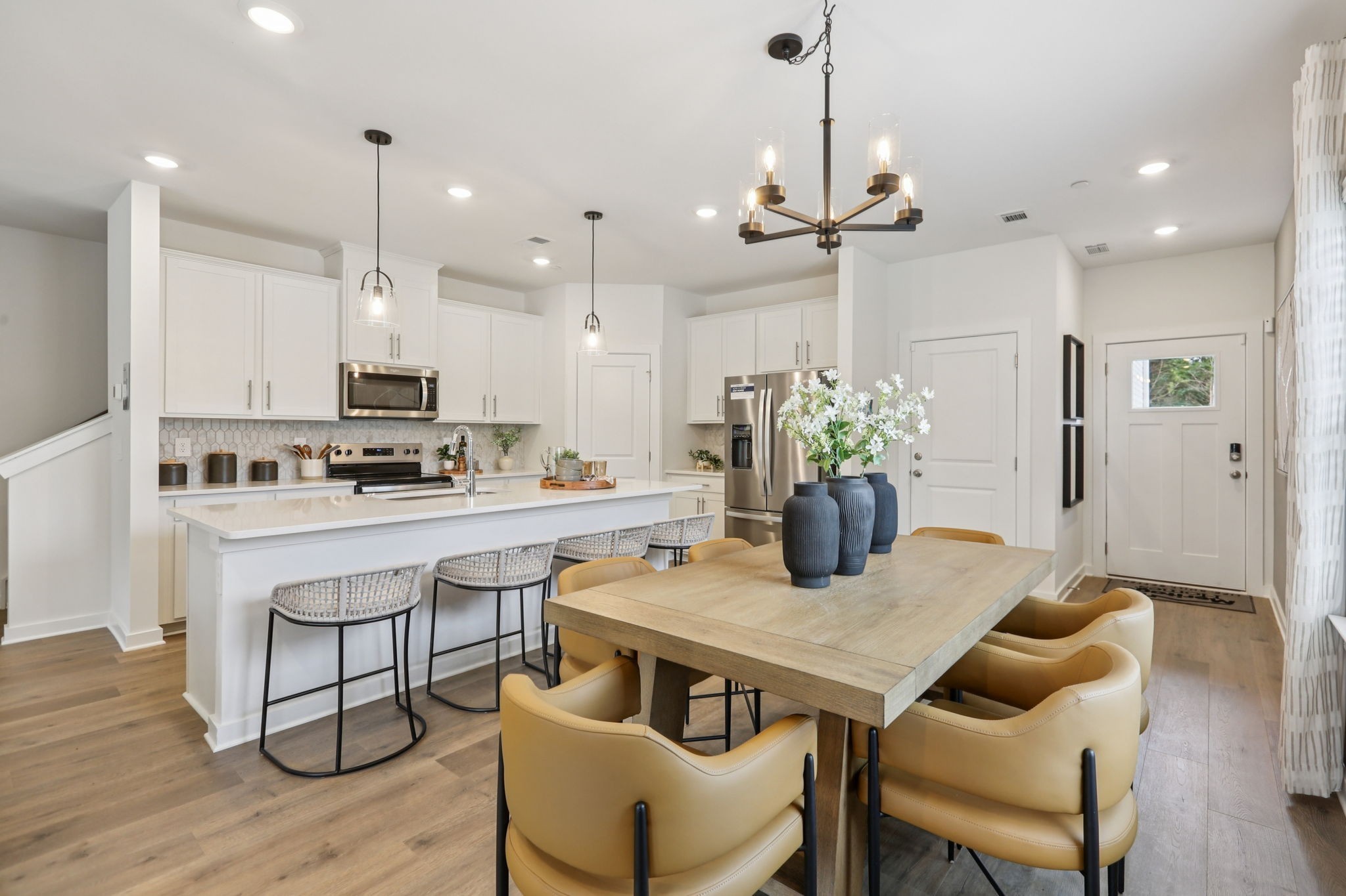 7165 Cedarcrest Lane Fairview, TN 37062 - Photo 11 of 49 a kitchen with kitchen island a dining table chairs stainless steel appliances and cabinets
