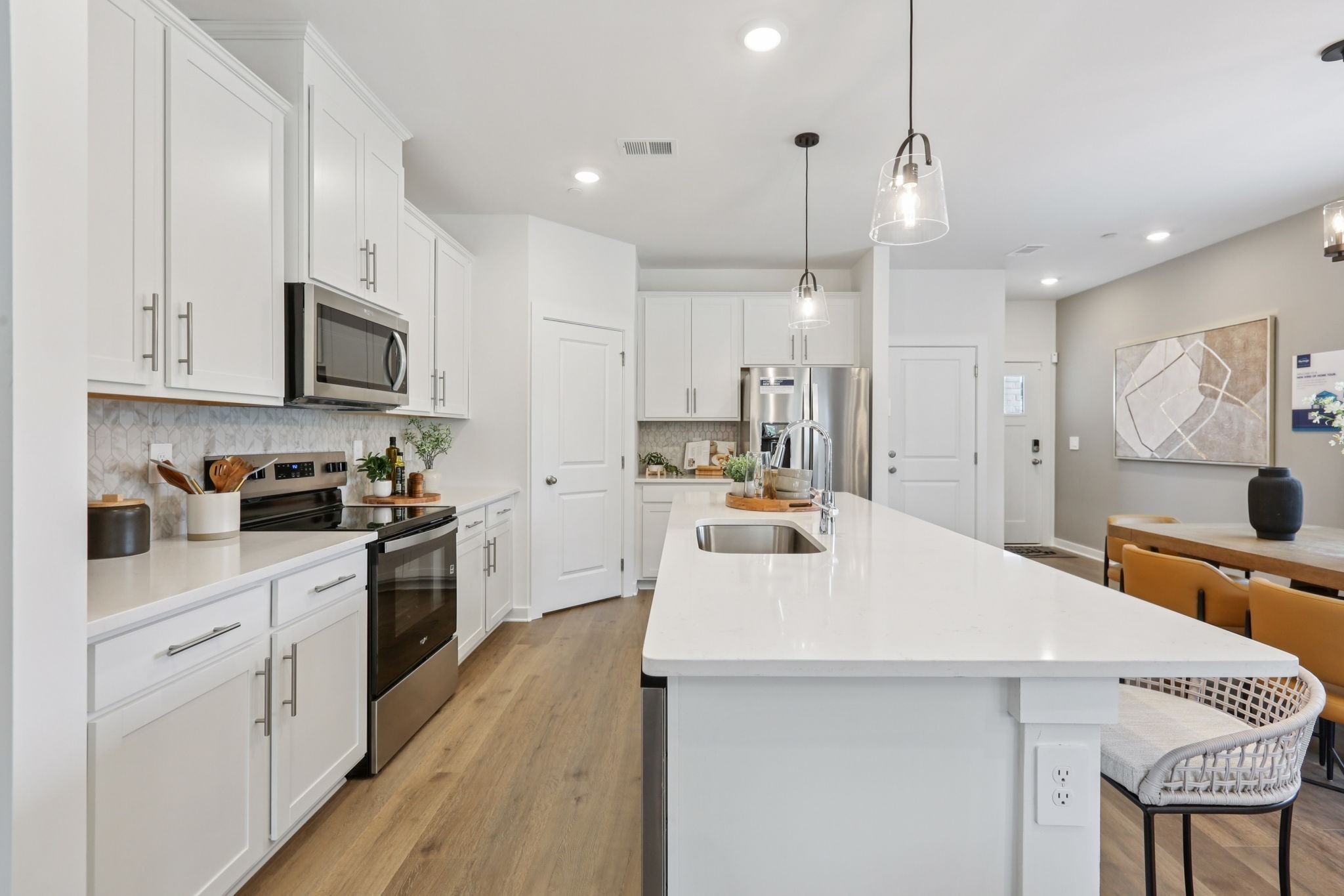 7165 Cedarcrest Lane Fairview, TN 37062 - Photo 12 of 49 a kitchen with white cabinets and stainless steel appliances