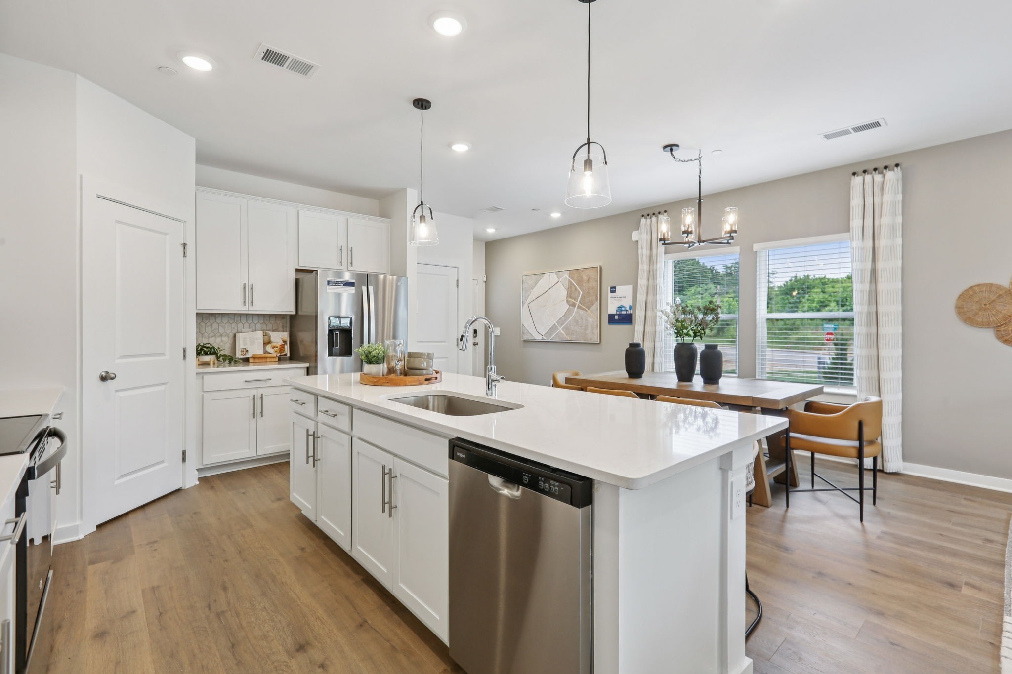 7165 Cedarcrest Lane Fairview, TN 37062 - Photo 13 of 49 a kitchen with stainless steel appliances granite countertop a stove a sink a kitchen island with chairs and wooden floor