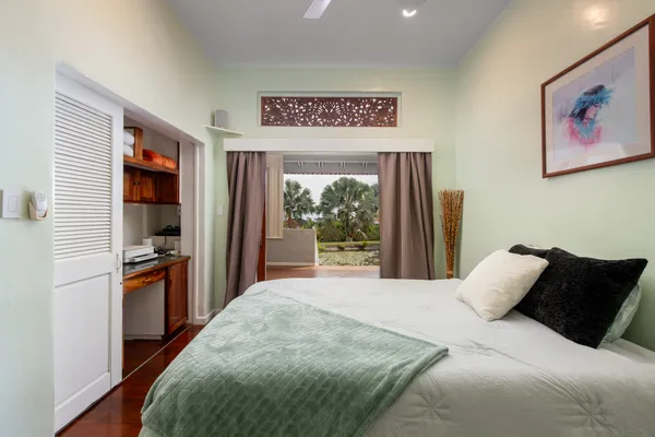a bedroom with a large bed and a large window