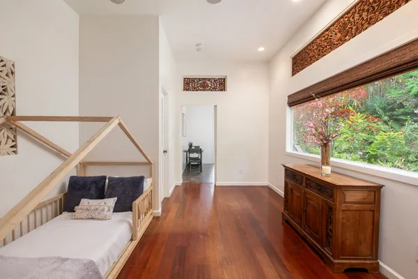 a bedroom with furniture and wooden floor