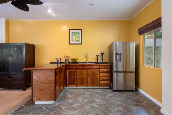 a kitchen with stainless steel appliances granite countertop a refrigerator and a sink